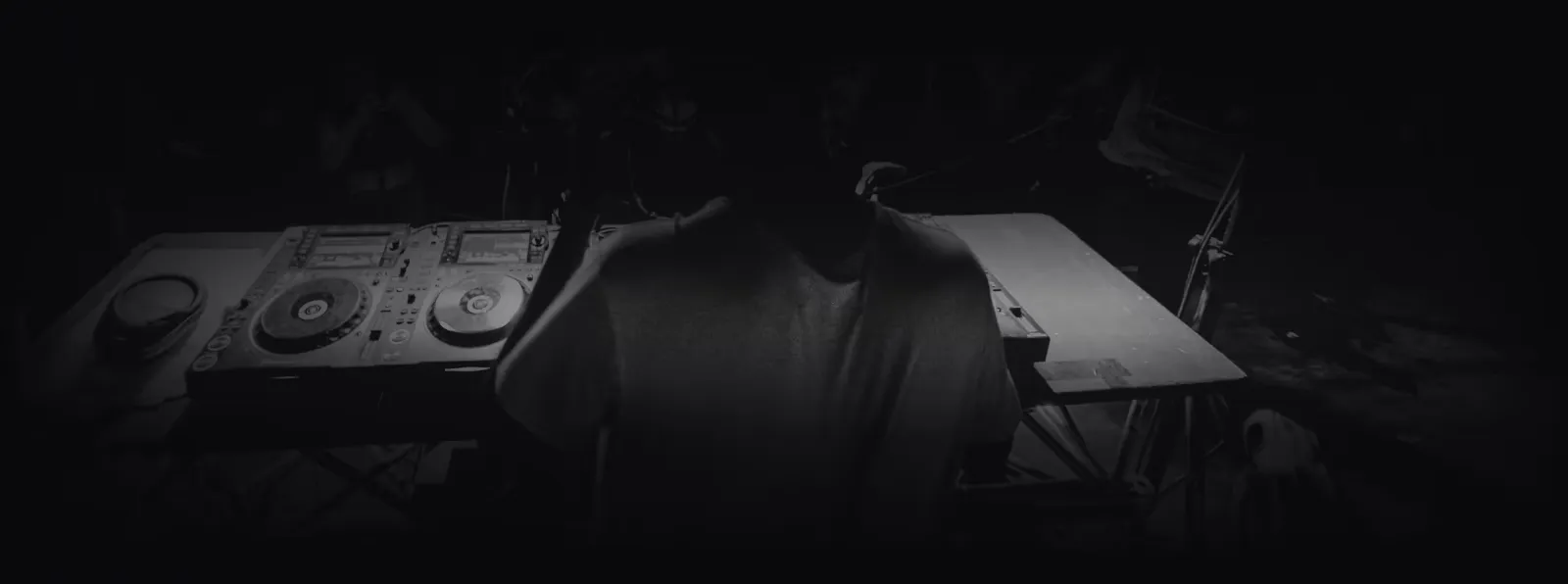 A DJ performing on turntables at a GigFinesse show